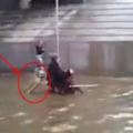 輪椅上的人在積水中移動，背後卻沒人推，漸漸靠近發現感人一幕！